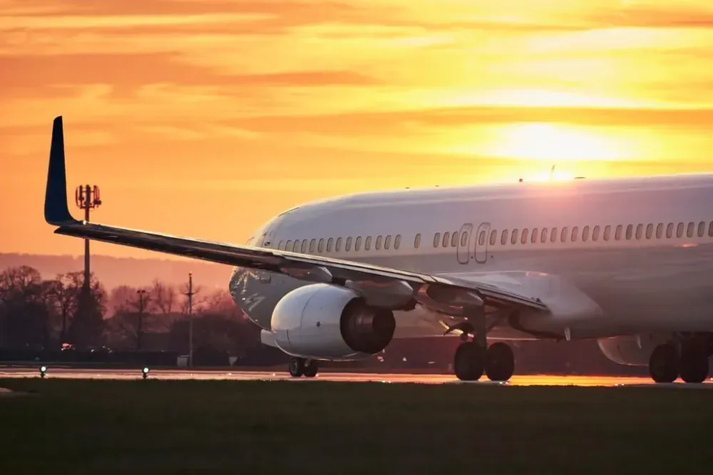 Plane on the runway at sunset